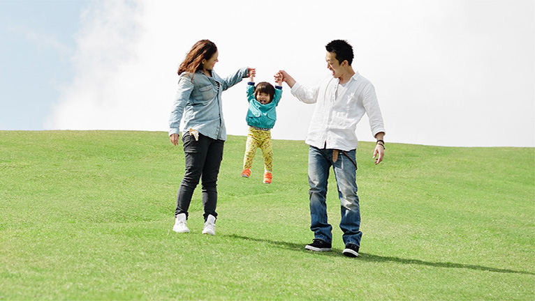 Parents lifting daughter up in the air 